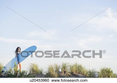 Female surfer walking on beach View Large Photo Image Stock Image - Female surfer walking on beach. Fotosearch