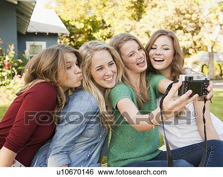 Four friends taking picture of themselves View Large Photo Image Stock Photograph - Four friends taking picture of themselves. Fotosearch