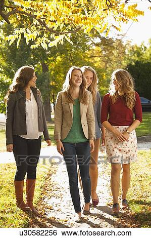 Four friends walking in autumn day View Large Photo Image Stock Photograph - Four friends walking in autumn day. Fotosearch
