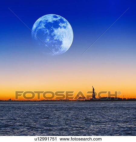 Stock Image - Full moon over Statue of Liberty. Fotosearch