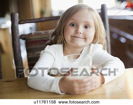 Girl (4-5) drinking milk in kitchen View Large Photo Image Stock Photo - Girl (4-5) drinking milk in kitchen. Fotosearch