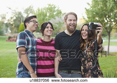 Stock Photograph - Group of friends taking pictures. Fotosearch