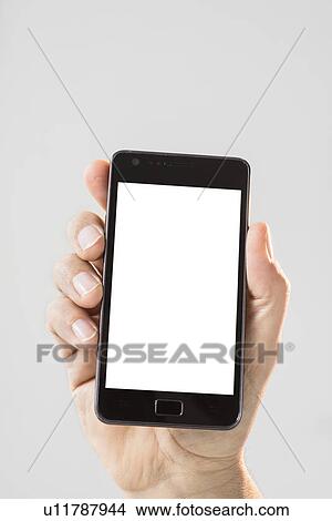 Picture - Hand holding smartphone. Fotosearch