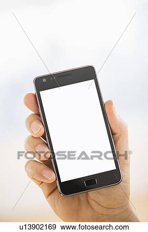 Hand holding smartphone View Large Photo Image Stock Photo - Hand holding smartphone. Fotosearch