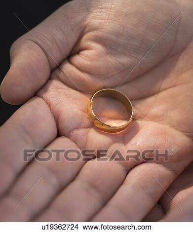 Hand holding wedding ring View Large Photo Image Picture - Hand holding wedding ring. Fotosearch