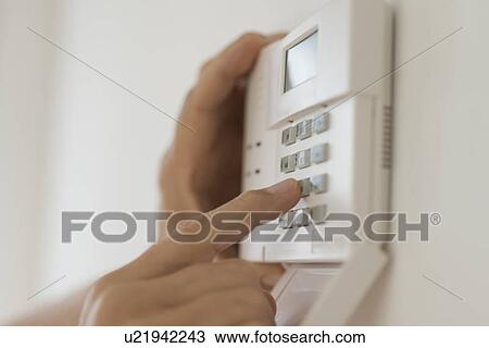 Hand setting code on burglar alarm View Large Photo Image Stock Image - Hand setting code on burglar alarm. Fotosearch