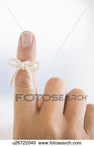 Hand with reminder bow on finger View Large Photo Image Stock Photo - Hand with reminder bow on finger. Fotosearch