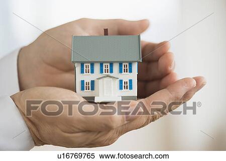 Hands holding model house View Large Photo Image Stock Photography - Hands holding model house. Fotosearch