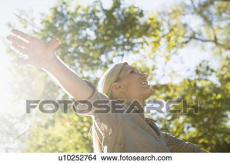 Picture - Happy woman outdoors. Fotosearch