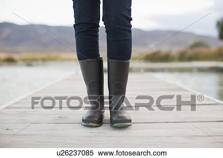 Low section of woman standing on jetty View Large Photo Image Stock Photography - Low section of woman standing on jetty. Fotosearch