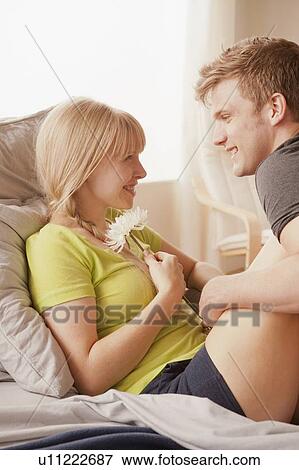 Man and woman sitting on bed and looking at each other View Large Photo Image Stock Photo - Man and woman sitting on bed and looking at each other. Fotosearch
