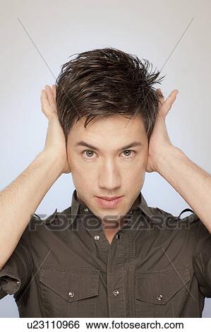 Stock Photograph - Man covering his ears. Fotosearch