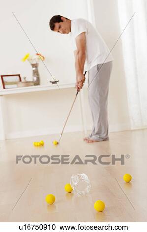 Man dressed in pajamas playing mini golf at home View Large Photo Image Stock Image - Man dressed in pajamas playing mini golf at home. Fotosearch