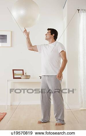 Man exercising with fitness ball View Large Photo Image Stock Photo - Man exercising with fitness ball. Fotosearch