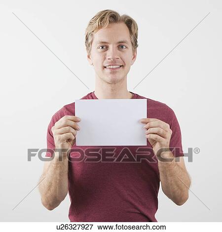 Stock Photo - Man holding blank paper sheet. Fotosearch