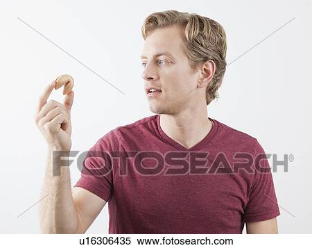 Man holding fortune cookie View Large Photo Image Stock Photography - Man holding fortune cookie. Fotosearch