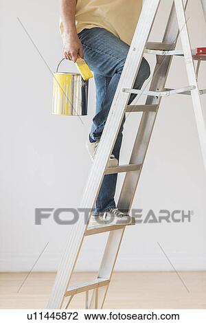 Man holding paint can and climbing ladder View Large Photo Image Stock Image - Man holding paint can and climbing ladder. Fotosearch