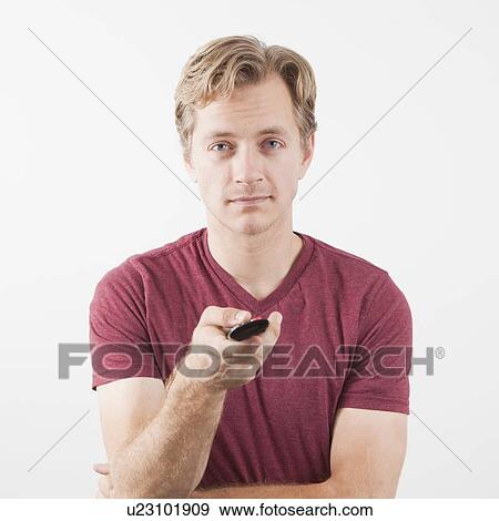 Man holding remote control View Large Photo Image Stock Photo - Man holding remote control. Fotosearch