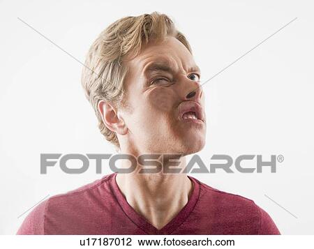 Stock Image - Man pushing his face against glass. Fotosearch