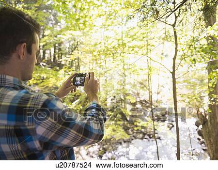 Man taking picture in forest View Large Photo Image Picture - Man taking picture in forest. Fotosearch