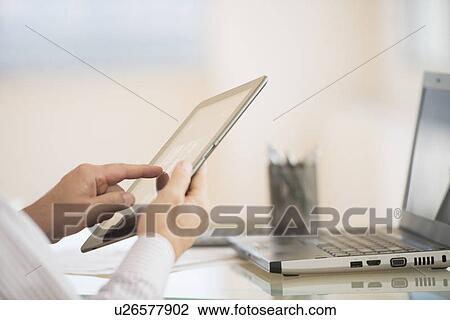 Stock Image - Man using tablet pc. Fotosearch
