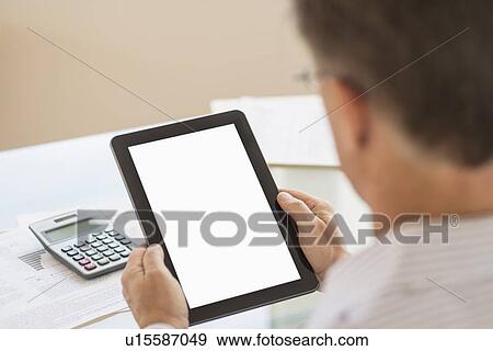 Man using tablet pc View Large Photo Image Stock Photo - Man using tablet pc. Fotosearch