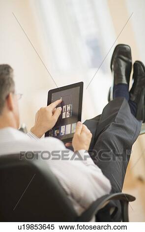 Man using tablet pc View Large Photo Image Stock Photography - Man using tablet pc. Fotosearch