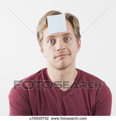 Man with adhesive note on his forehead View Large Photo Image Stock Image - Man with adhesive note on his forehead. Fotosearch