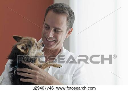 Mature man playing with dog View Large Photo Image Stock Photograph - Mature man playing with dog. Fotosearch