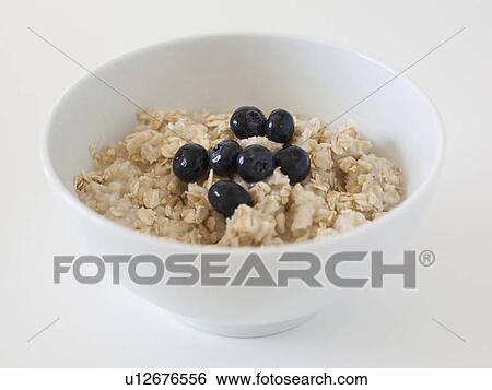 Stock Photograph - Oatmeal with blueberries on white background. Fotosearch