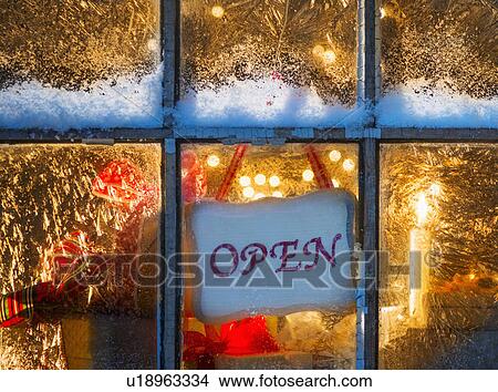 Picture - Open sign hanging in window with Christmas lights. Fotosearch