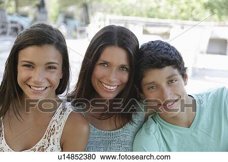 Outdoor portrait of smiling mother with daughter (12-13) and son (14-15) View Large Photo Image Stock Image - Outdoor portrait of smiling mother with daughter (12-13) and son (14-15). Fotosearch