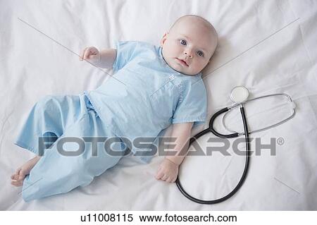 Stock Photography - Portrait of baby boy (2-5 months) with stethoscope. Fotosearch