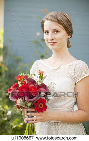 Stock Photo - Portrait of bride holding bouquet. Fotosearch