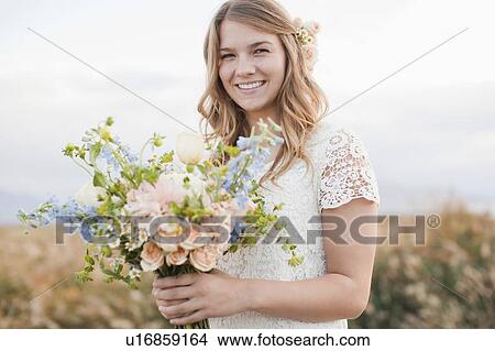 Portrait of bride holding bunch of flowers View Large Photo Image Picture - Portrait of bride holding bunch of flowers. Fotosearch