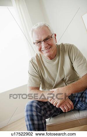 Stock Image - Portrait of cheerful senior man wearing spectacles. Fotosearch