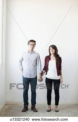 Portrait of couple holding hands indoors View Large Photo Image Stock Image - Portrait of couple holding hands indoors. Fotosearch