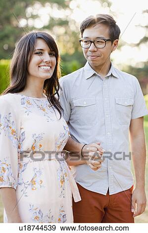 Portrait of couple in park View Large Photo Image Stock Photo - Portrait of couple in park. Fotosearch