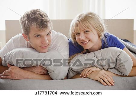 Portrait of couple lying in bed View Large Photo Image Picture - Portrait of couple lying in bed. Fotosearch