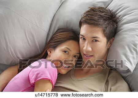 Portrait of couple lying in bed View Large Photo Image Stock Photo - Portrait of couple lying in bed. Fotosearch