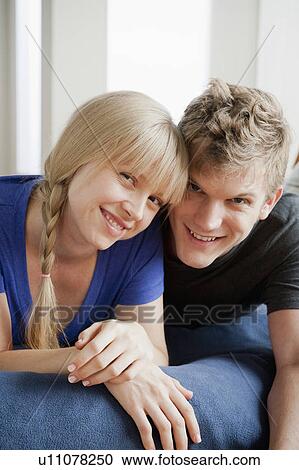 Portrait of couple lying on bed and smiling View Large Photo Image Stock Image - Portrait of couple lying on bed and smiling. Fotosearch
