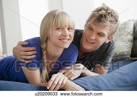 Portrait of couple lying on bed and smiling View Large Photo Image Stock Image - Portrait of couple lying on bed and smiling. Fotosearch