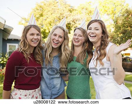Portrait of four friends wearing party hat View Large Photo Image Stock Image - Portrait of four friends wearing party hat. Fotosearch