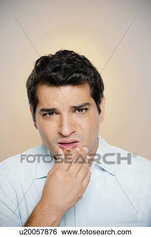 Stock Photograph - Portrait of man expressing uncertainty. Fotosearch