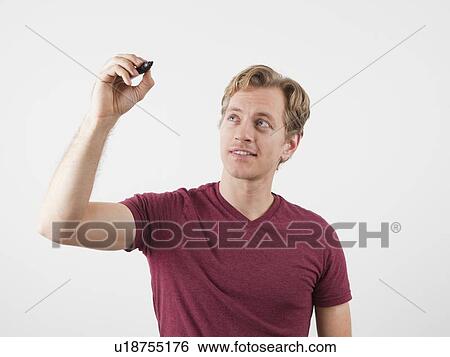 Portrait of man holding marker, ready to write View Large Photo Image Stock Photograph - Portrait of man holding marker, ready to write. Fotosearch