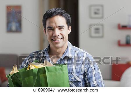 Stock Photo - Portrait of man with shopping bags. Fotosearch