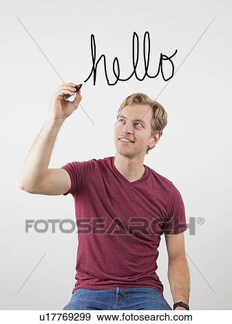 Portrait of man writing hello above his head View Large Photo Image Stock Photo - Portrait of man writing hello above his head. Fotosearch