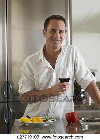 Stock Image - Portrait of mature man with wine glass. Fotosearch