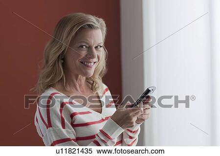 Portrait of mature woman texting View Large Photo Image Stock Photography - Portrait of mature woman texting. Fotosearch