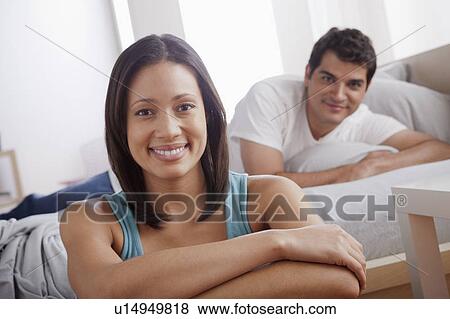 Stock Photo - Portrait of mid adult couple in bedroom. Fotosearch